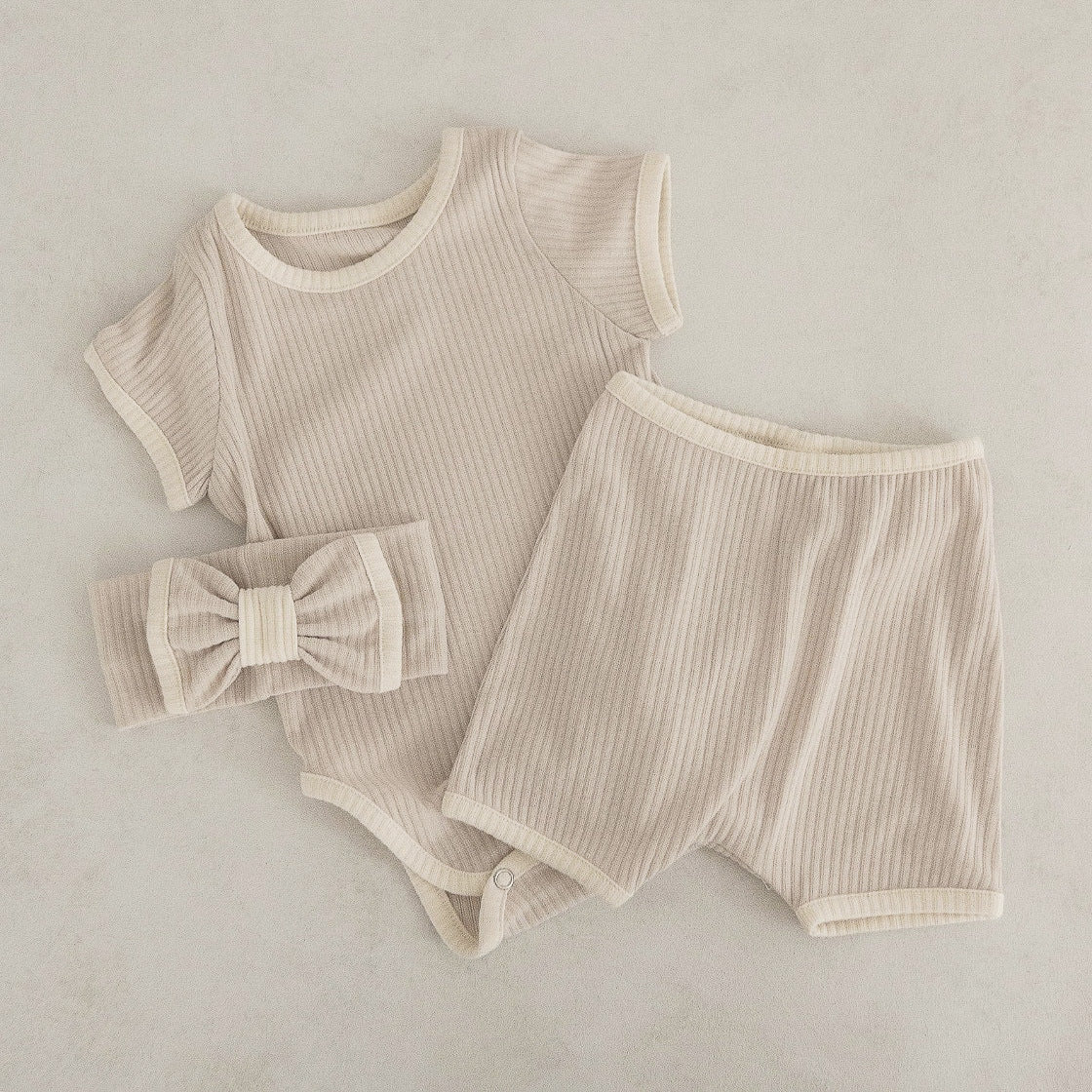 Baby unisex solid color comfy cotton onesies and shorts sets in white, pink, yellow, and apricot, perfect for summer wear.