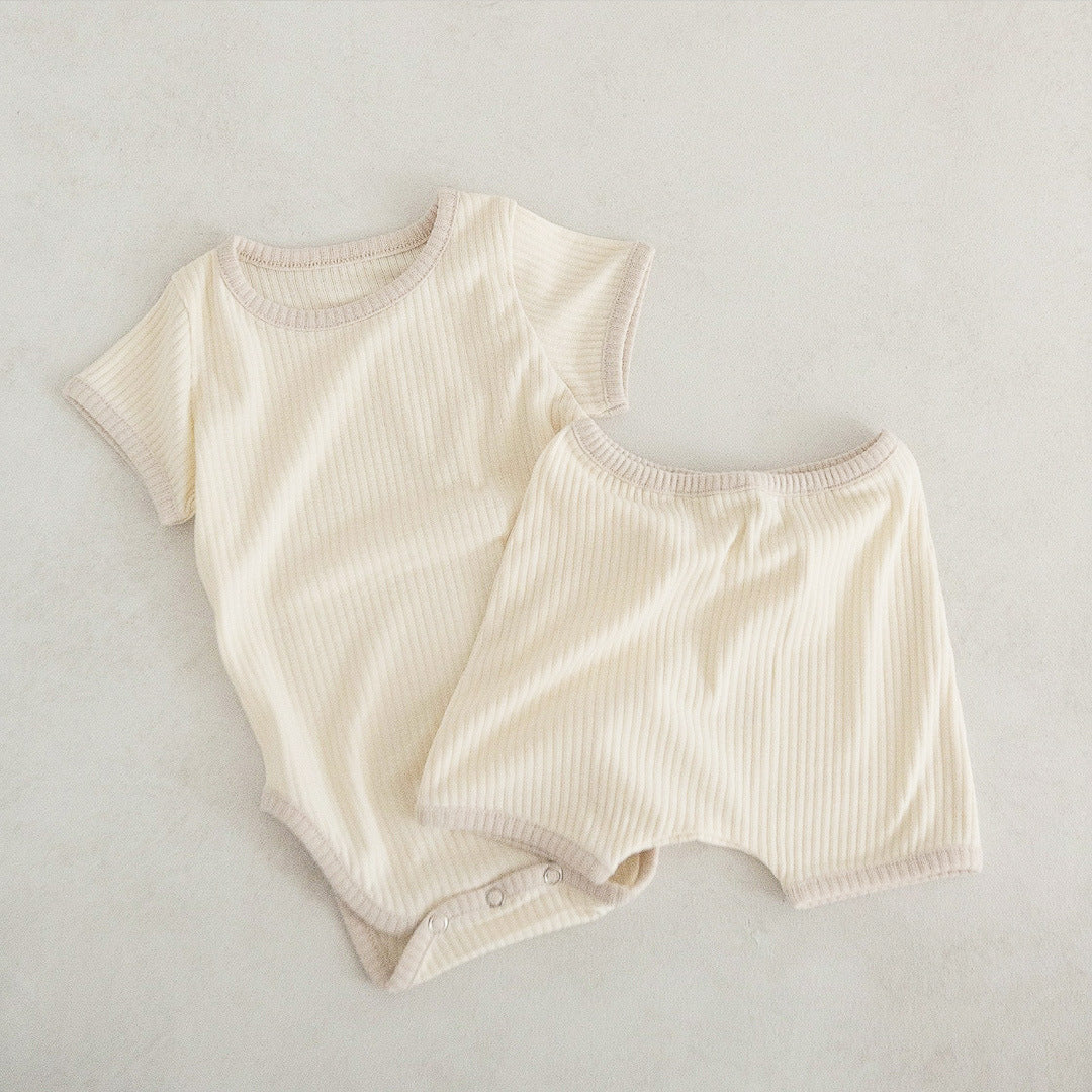 Baby unisex solid color comfy cotton onesies and shorts sets in white, pink, yellow, and apricot, perfect for summer wear.