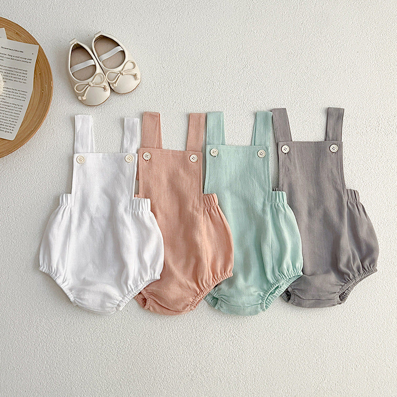 Baby wearing unisex solid color overalls in pink, showcasing a comfortable and stylish design suitable for spring and summer.