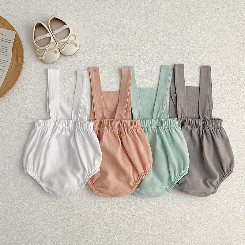 Baby wearing unisex solid color overalls in pink, showcasing a comfortable and stylish design suitable for spring and summer.