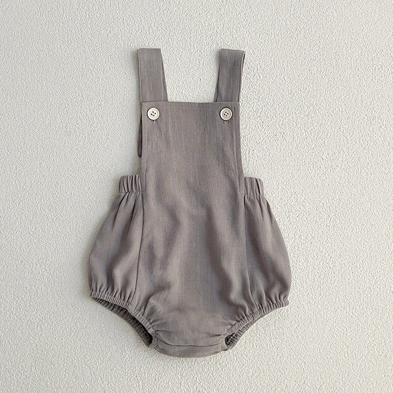 Baby wearing unisex solid color overalls in pink, showcasing a comfortable and stylish design suitable for spring and summer.