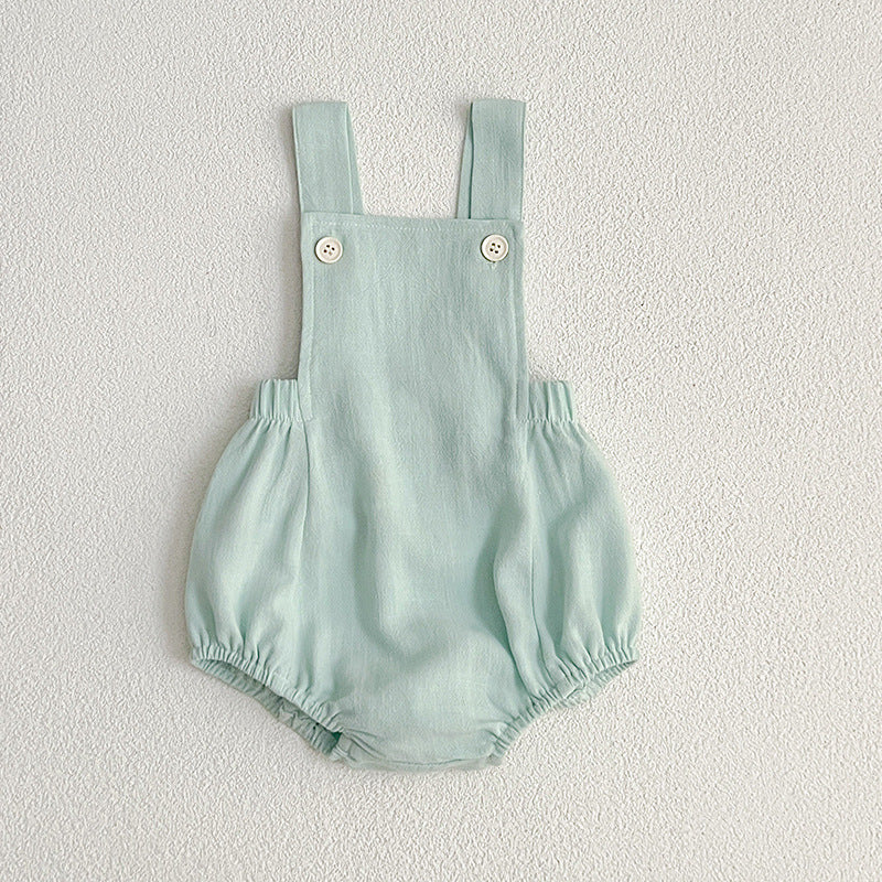 Baby wearing unisex solid color overalls in pink, showcasing a comfortable and stylish design suitable for spring and summer.