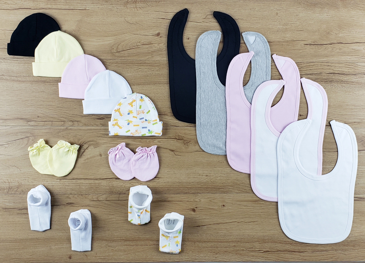 Bambini 14 PC set featuring soft cotton bibs, caps, and booties in various colors, perfect for newborns.