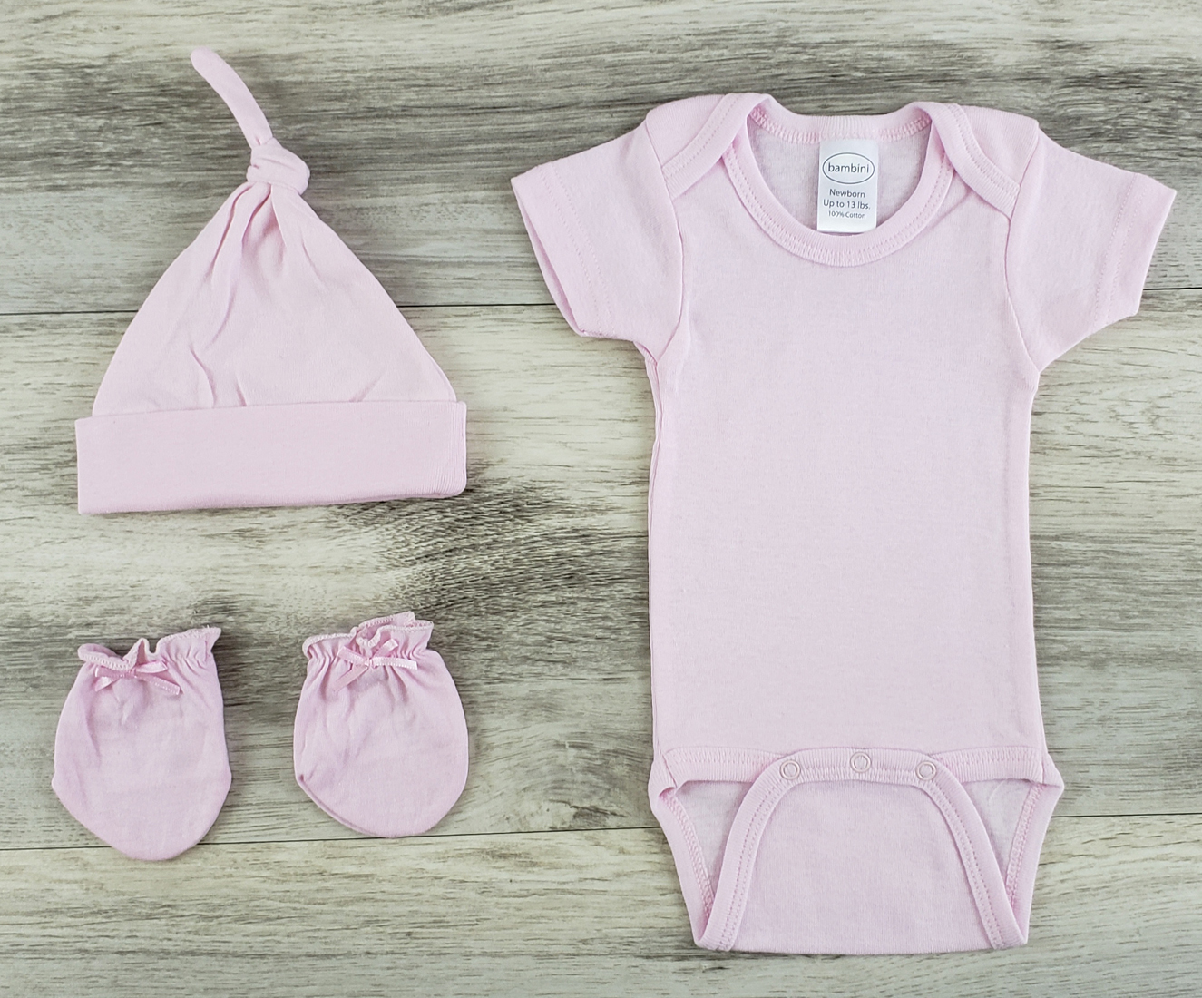 Bambini 3 Pc Layette Baby Clothes Set featuring a pink onesie, knotted cap, and infant mittens made from soft cotton.