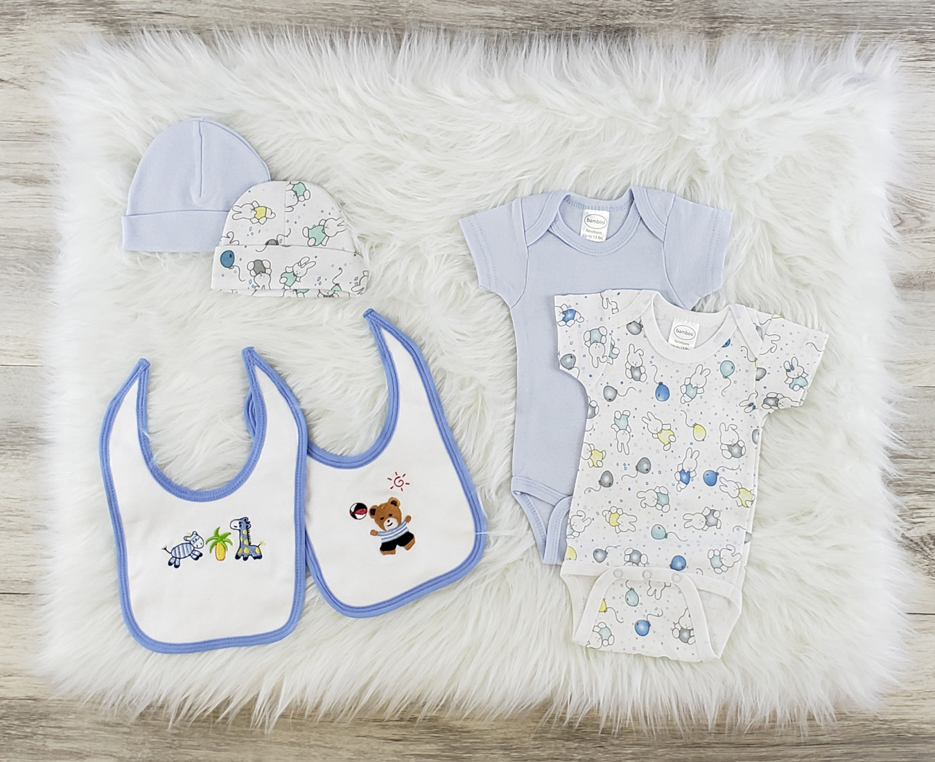 Bambini 6 Pc Layette Baby Clothes Set featuring soft cotton onesies, bibs, and baby caps in blue and white colors.