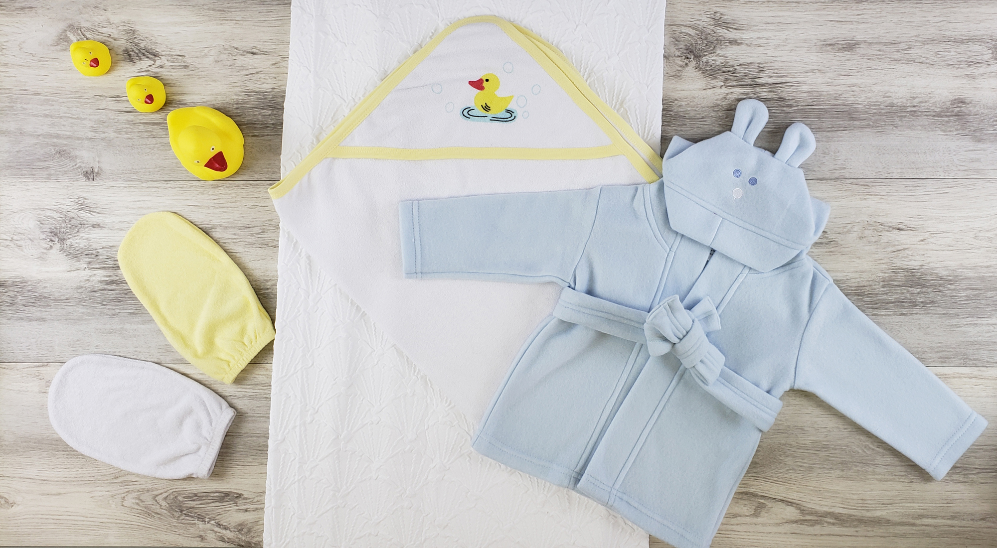 Bambini Hooded Towel set featuring a soft cotton towel, bath mittens, and a cozy blue fleece robe with a hood, perfect for newborns.