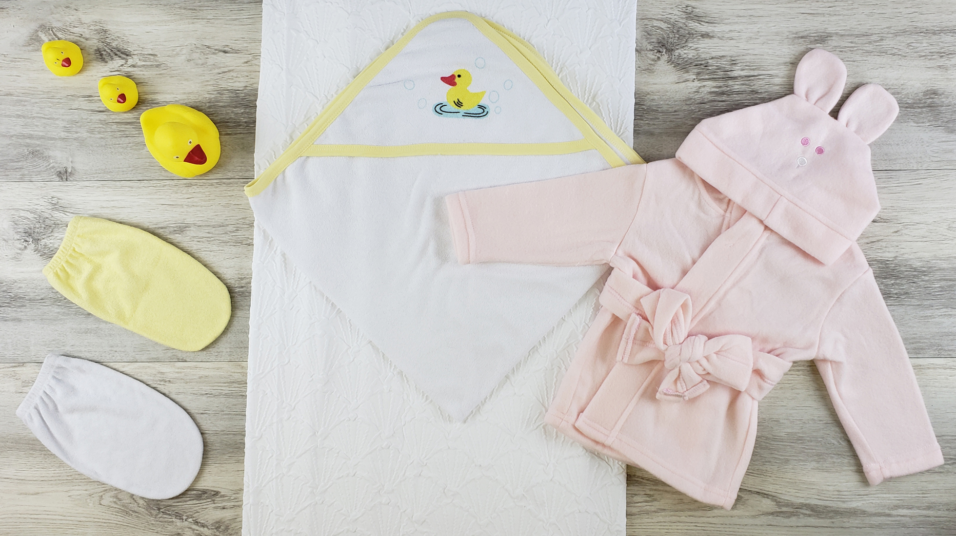 Bambini Hooded Towel, Bath Mittens, and Pink Fleece Robe set for newborns, showcasing soft cotton fabric and cozy design.