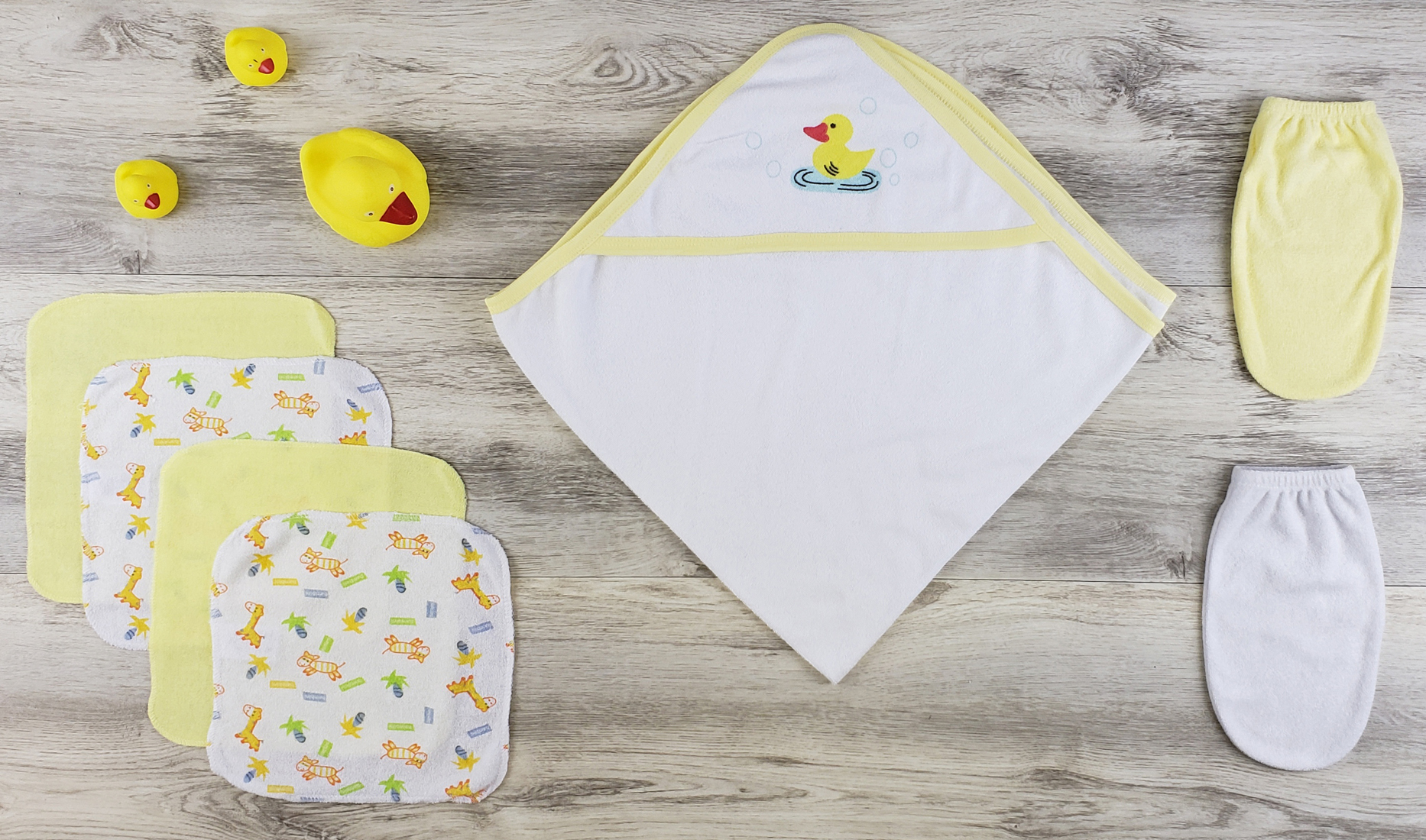 Bambini Hooded Towel set featuring soft cotton materials, including a yellow fleece robe, washcloths, and bath mittens for newborns.