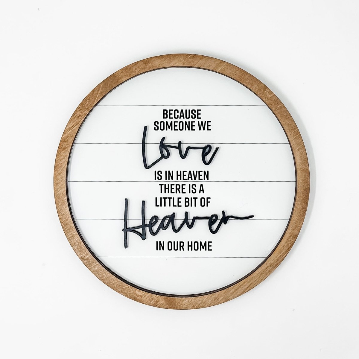 10-inch round wood sign with black laser cut lettering on a white shiplap background, featuring a sawtooth hanger for easy display.