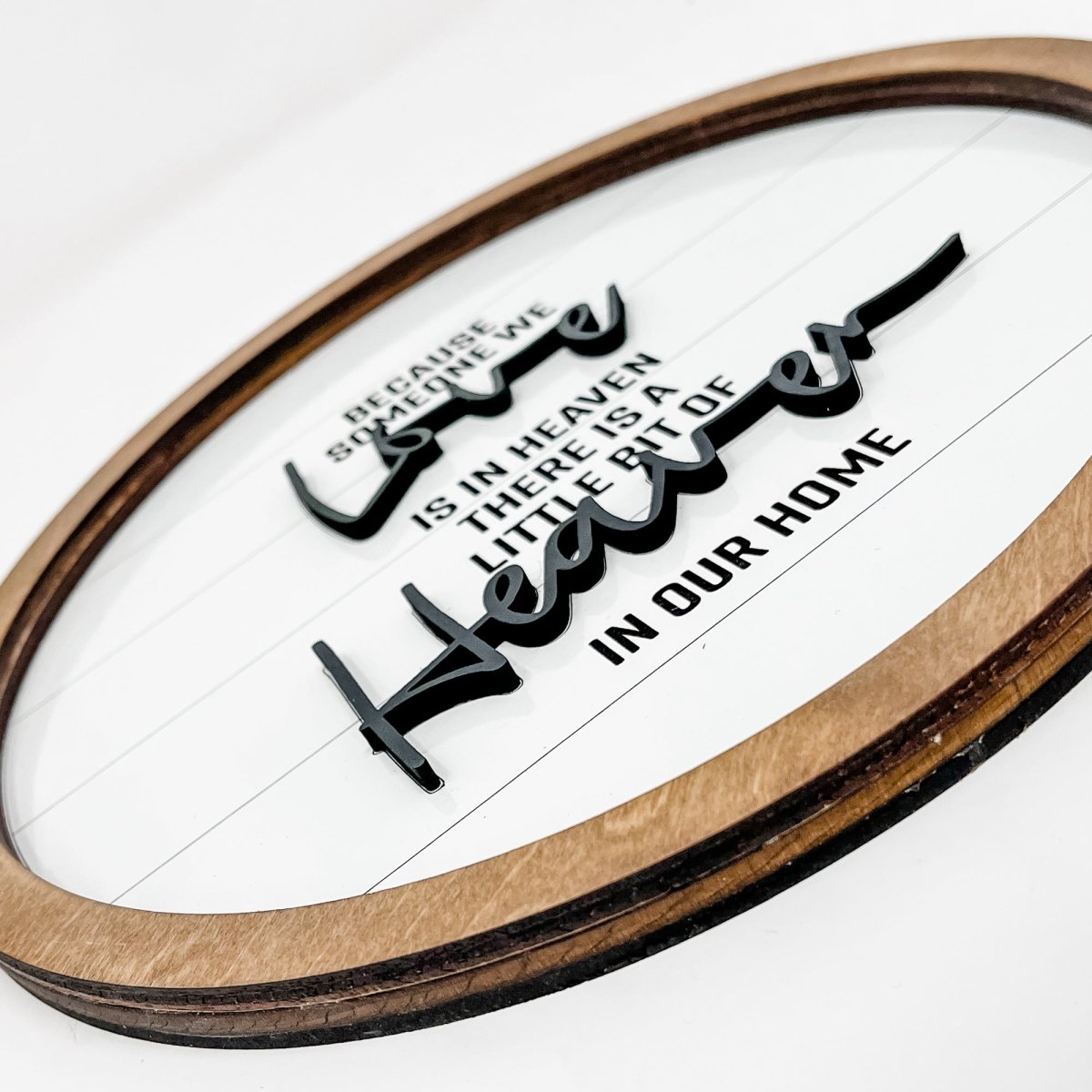 10-inch round wood sign with black laser cut lettering on a white shiplap background, featuring a sawtooth hanger for easy display.