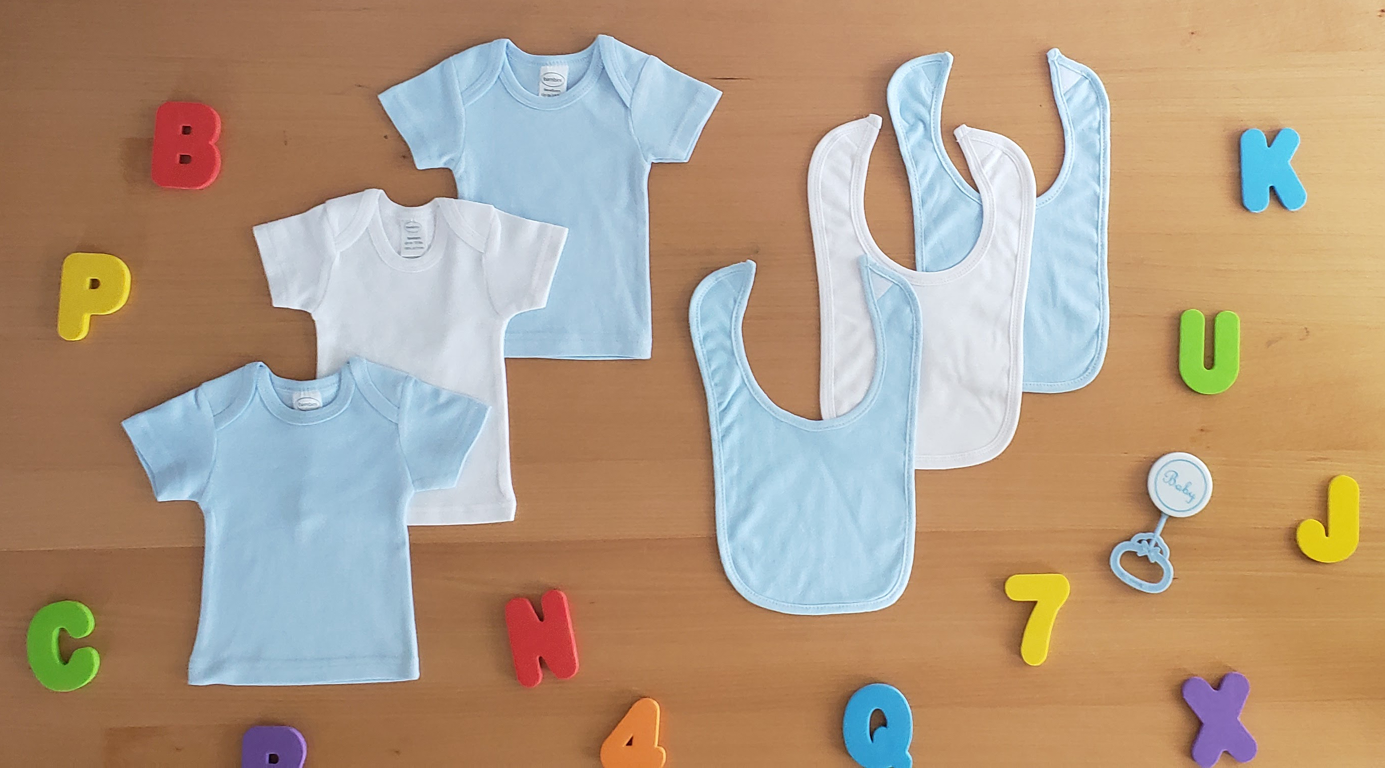 A set of blue and white cotton shirts with matching bibs for newborns, showcasing soft fabric and convenient design features.