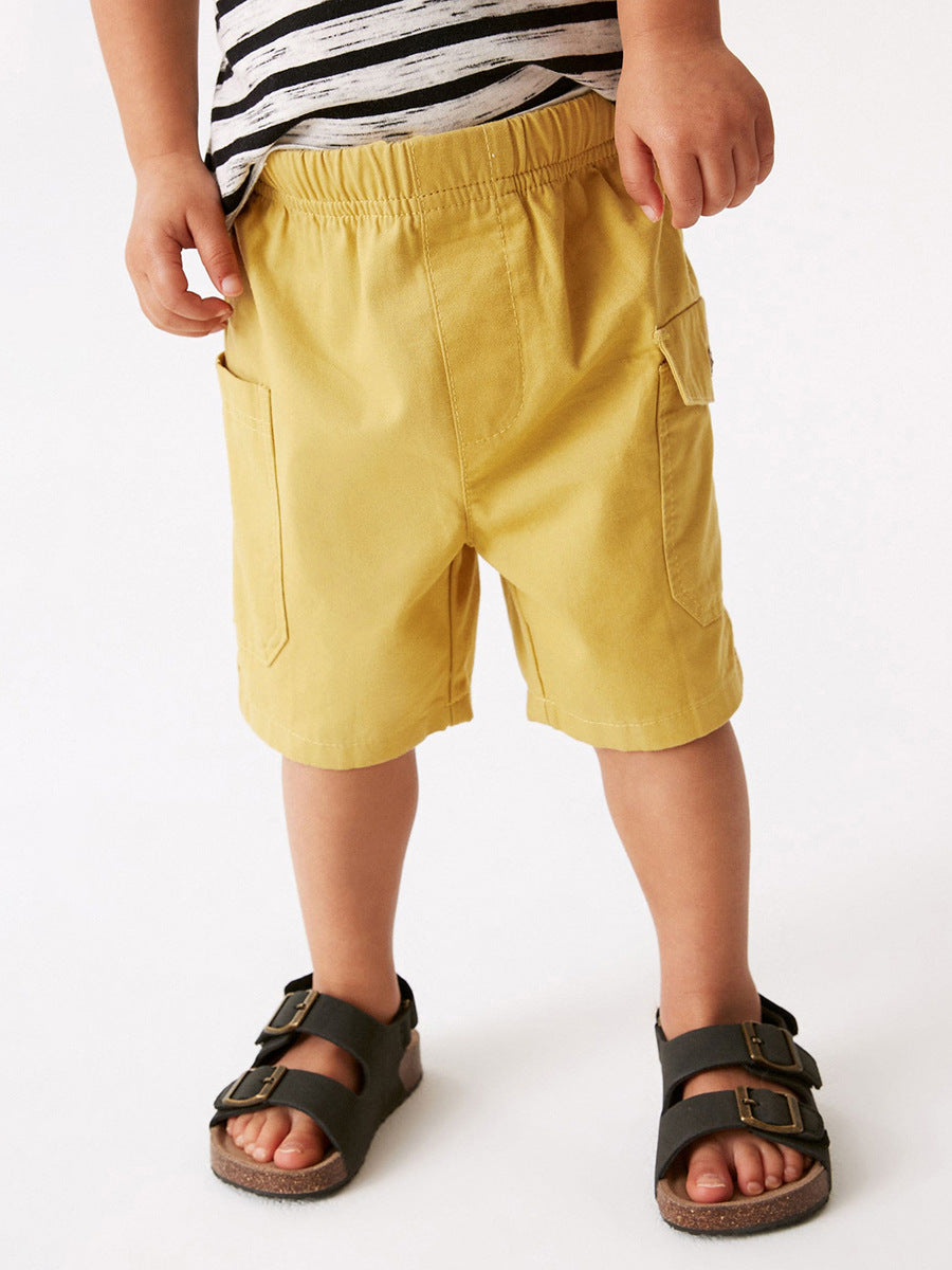 Boys solid yellow cotton casual shorts with pockets, perfect for summer wear.