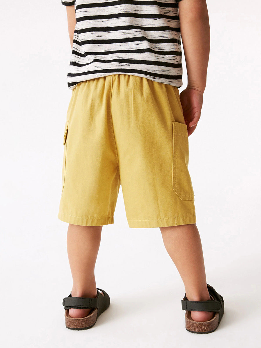Boys solid yellow cotton casual shorts with pockets, perfect for summer wear.