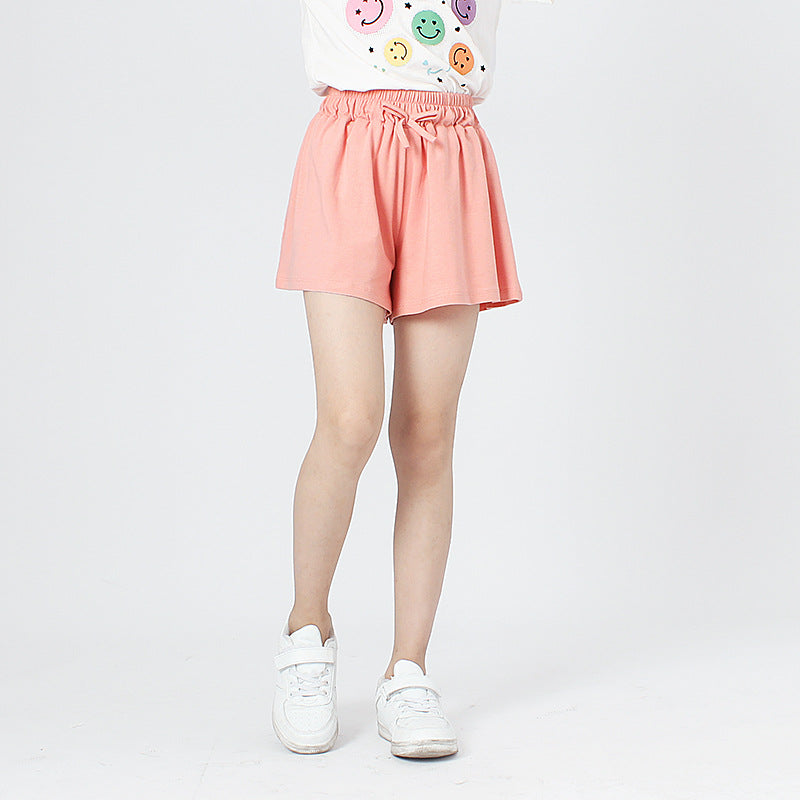 Children's solid color shorts in various colors, made from soft cotton, suitable for summer wear.