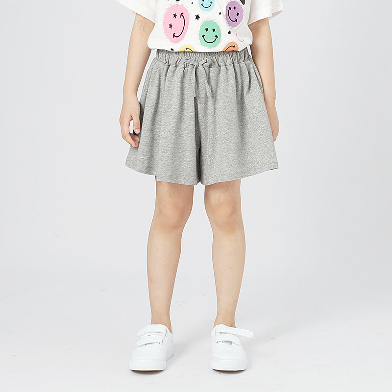 Children's solid color shorts in various colors, made from soft cotton, suitable for summer wear.