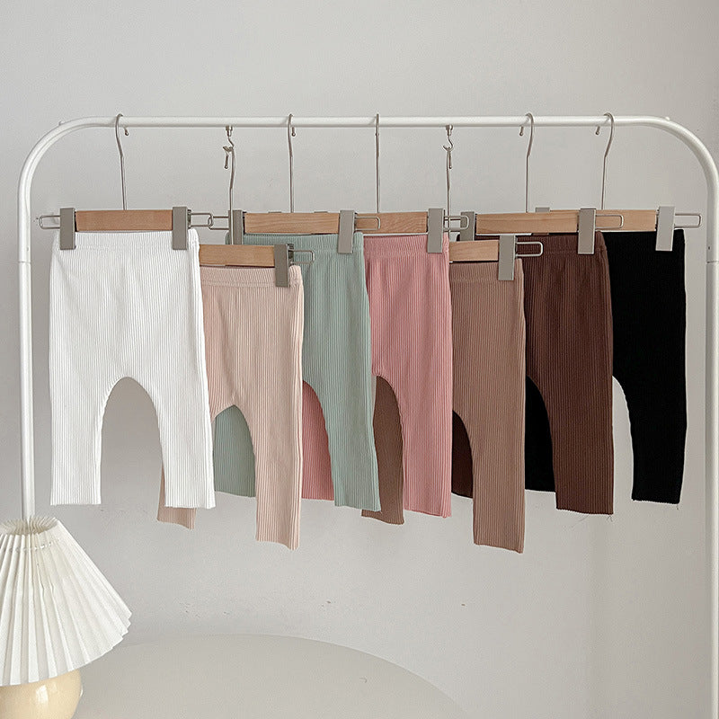 Children's autumn unisex solid color knitted breathable pants in white and apricot, showcasing soft cotton fabric and stylish design.