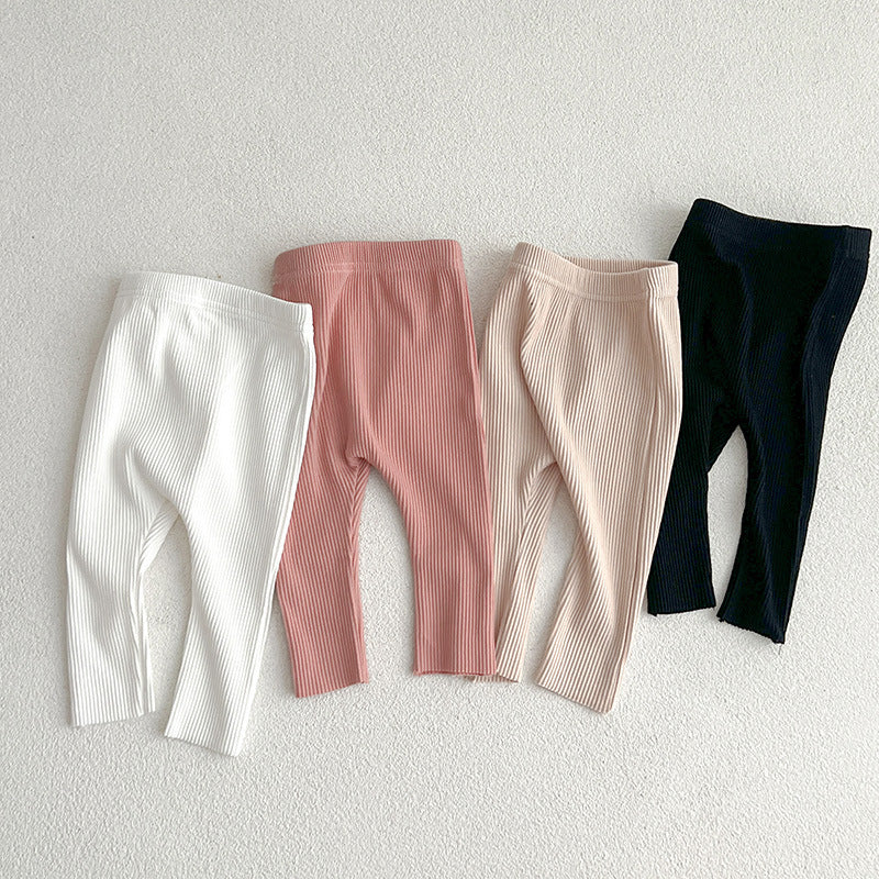 Children's autumn unisex solid color knitted breathable pants in white and apricot, showcasing soft cotton fabric and stylish design.