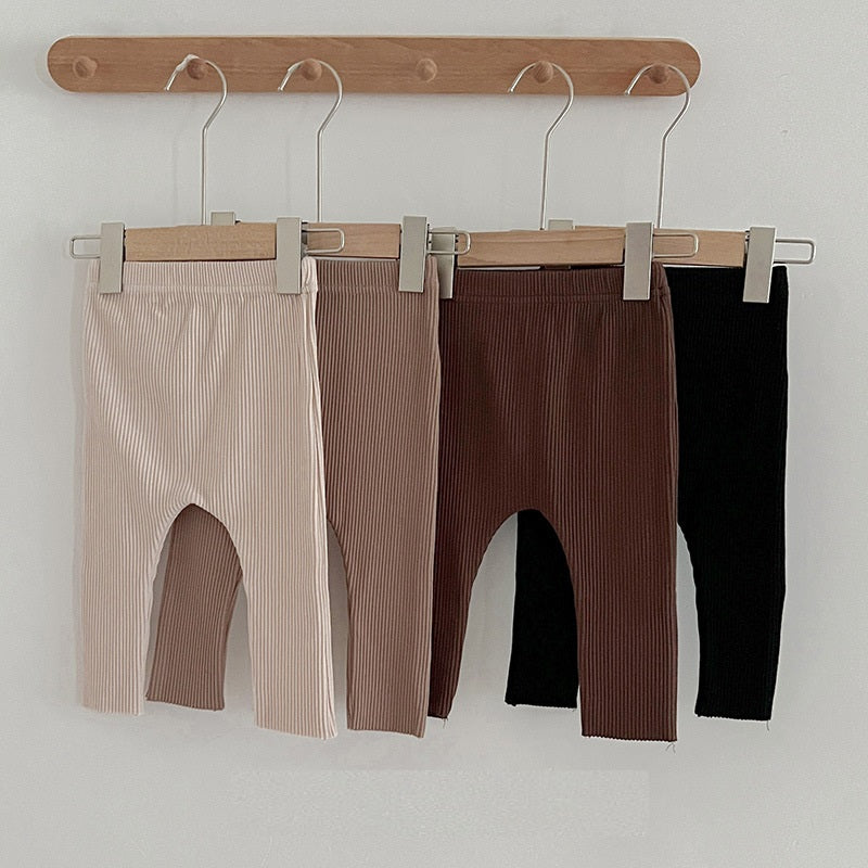Children's autumn unisex solid color knitted breathable pants in white and apricot, showcasing soft cotton fabric and stylish design.