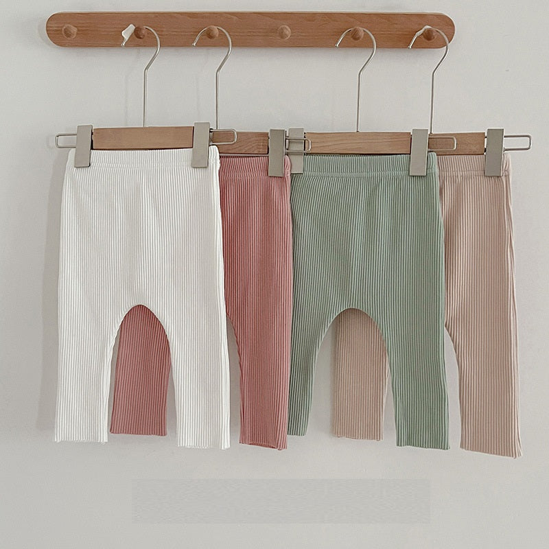 Children's autumn unisex solid color knitted breathable pants in white and apricot, showcasing soft cotton fabric and stylish design.