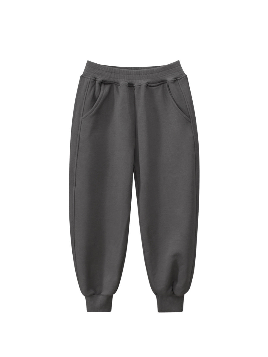 Children's solid color sportswear pants in black, navy blue, grey, and khaki, suitable for boys and girls.