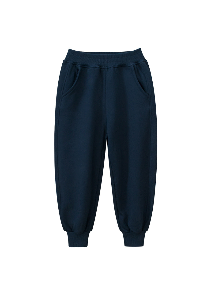 Children's solid color sportswear pants in black, navy blue, grey, and khaki, suitable for boys and girls.