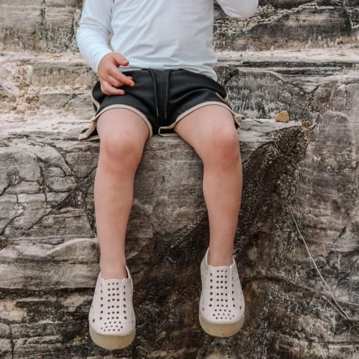 A modern curbside pickup service showcasing a vehicle parked outside a store, ready for order collection.