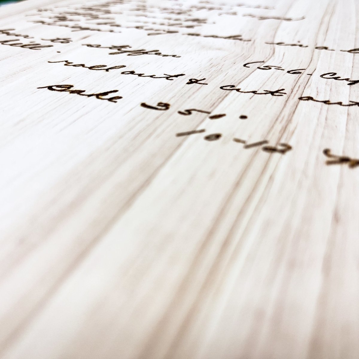 Custom Handwritten Cutting Board featuring a personalized handwritten recipe and decorative design, showcasing its unique craftsmanship.
