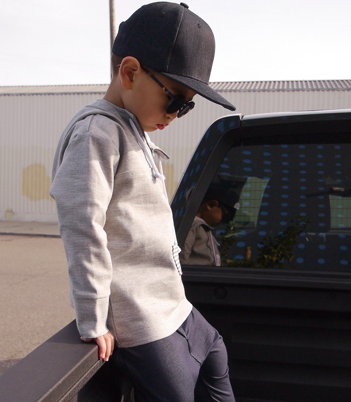 A stylish denim snapback cap for kids, featuring an adjustable snapback fastening and soft cotton material, suitable for ages 1-5.