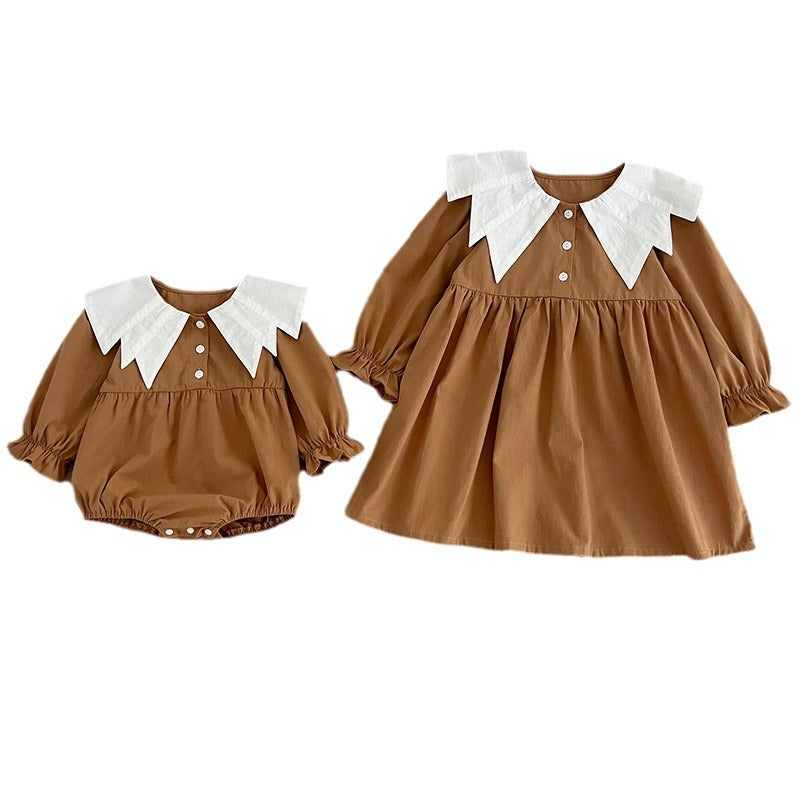 A stylish autumn patchwork dress for baby girls featuring a bat-wings shaped collar in brown and coffee colors.