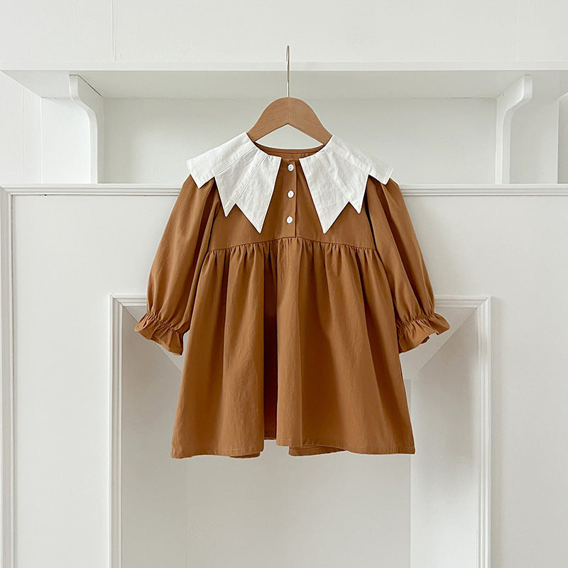 A stylish autumn patchwork dress for baby girls featuring a bat-wings shaped collar in brown and coffee colors.