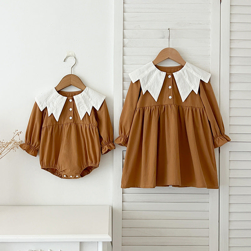 A stylish autumn patchwork dress for baby girls featuring a bat-wings shaped collar in brown and coffee colors.