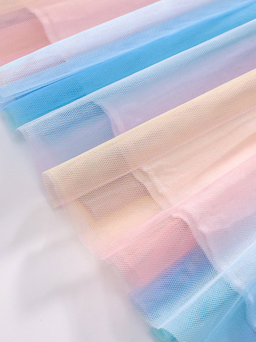 Colorful long sleeve shirt for girls featuring a cartoon rainbow and clouds pattern, made from soft cotton material.