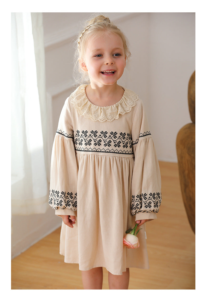 A stylish long dress for girls featuring floral and geometric patterns with a ruffle collar in apricot color.