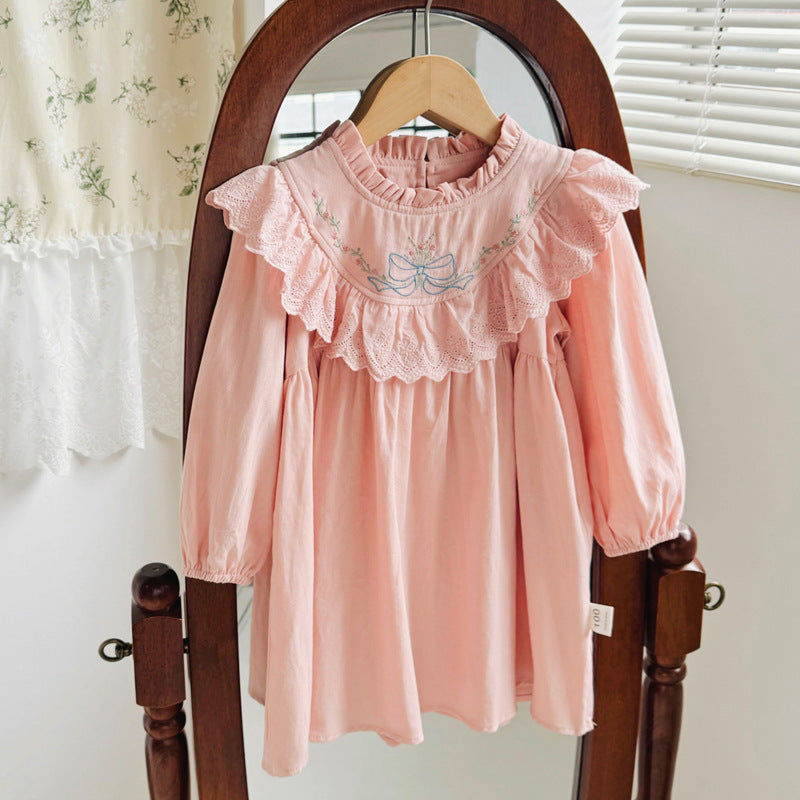 A beautiful long dress for girls featuring floral and bow embroidery, ruffle neck design, available in pink and beige colors.
