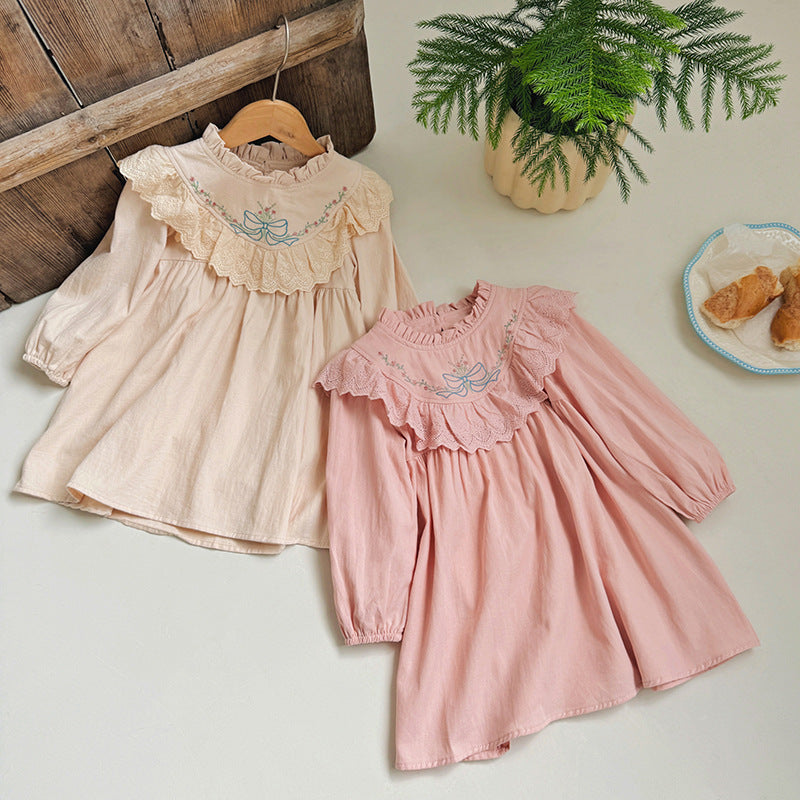 A beautiful long dress for girls featuring floral and bow embroidery, ruffle neck design, available in pink and beige colors.