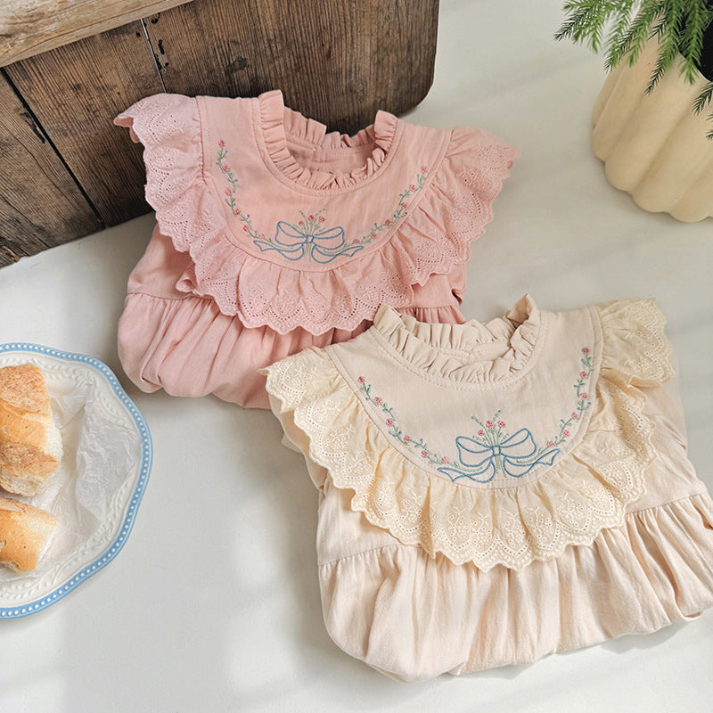 A beautiful long dress for girls featuring floral and bow embroidery, ruffle neck design, available in pink and beige colors.