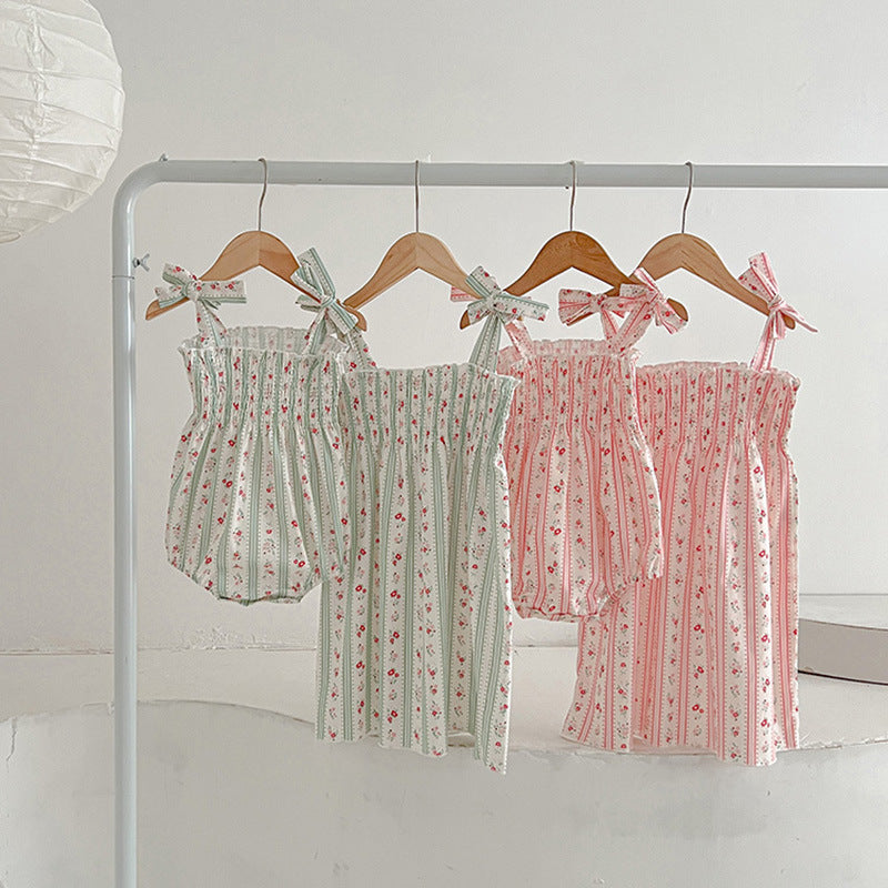 A vibrant summer dress for girls featuring floral and striped patterns, perfect for warm weather, available in pink and green colors.