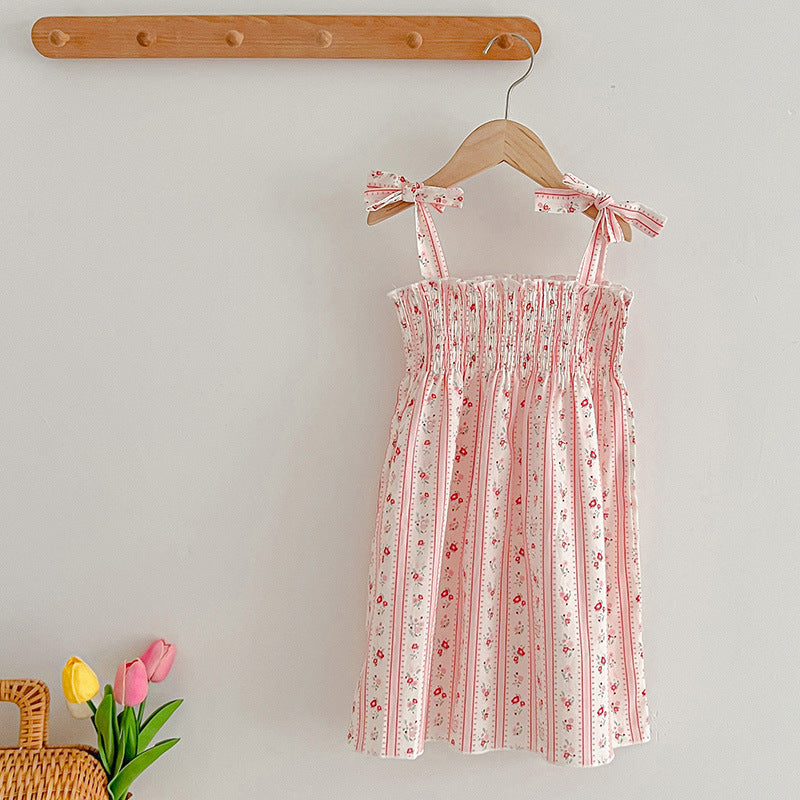 A vibrant summer dress for girls featuring floral and striped patterns, perfect for warm weather, available in pink and green colors.