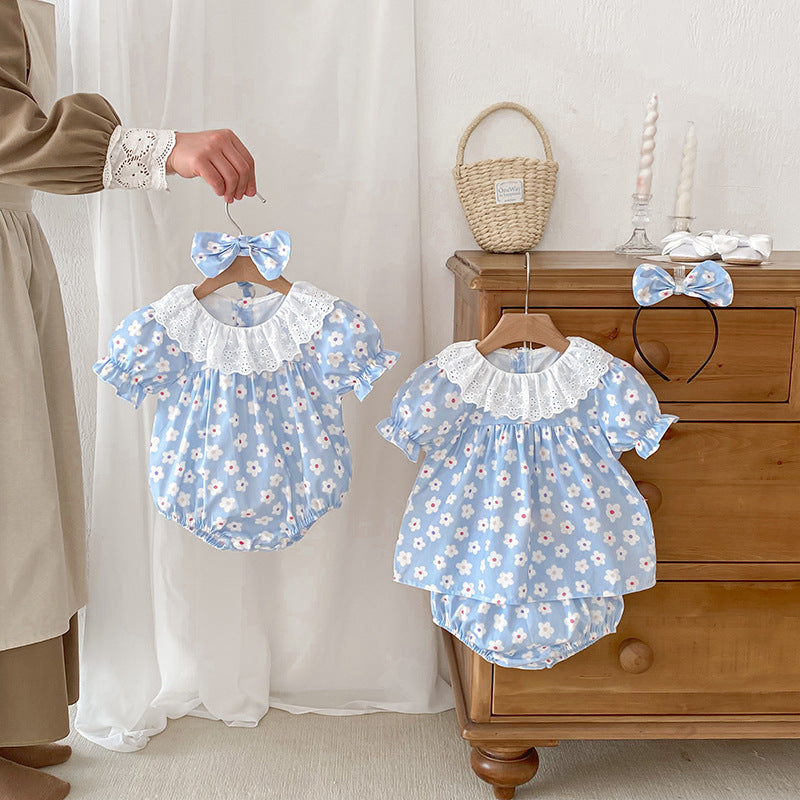 A cute summer dress for girls featuring a floral pattern, short sleeves, and a hollow out collar in blue and light blue colors.