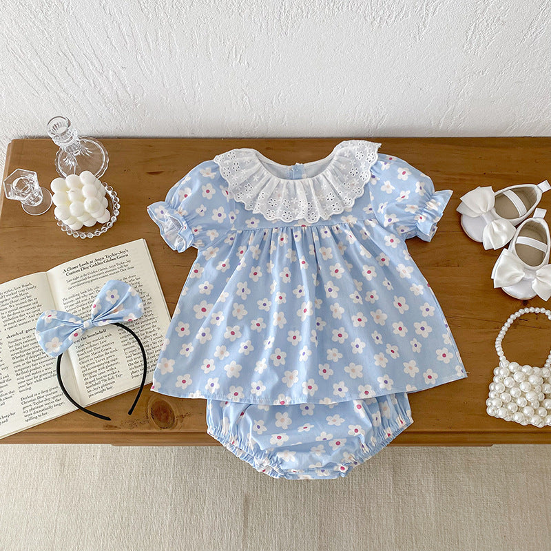 A cute summer dress for girls featuring a floral pattern, short sleeves, and a hollow out collar in blue and light blue colors.