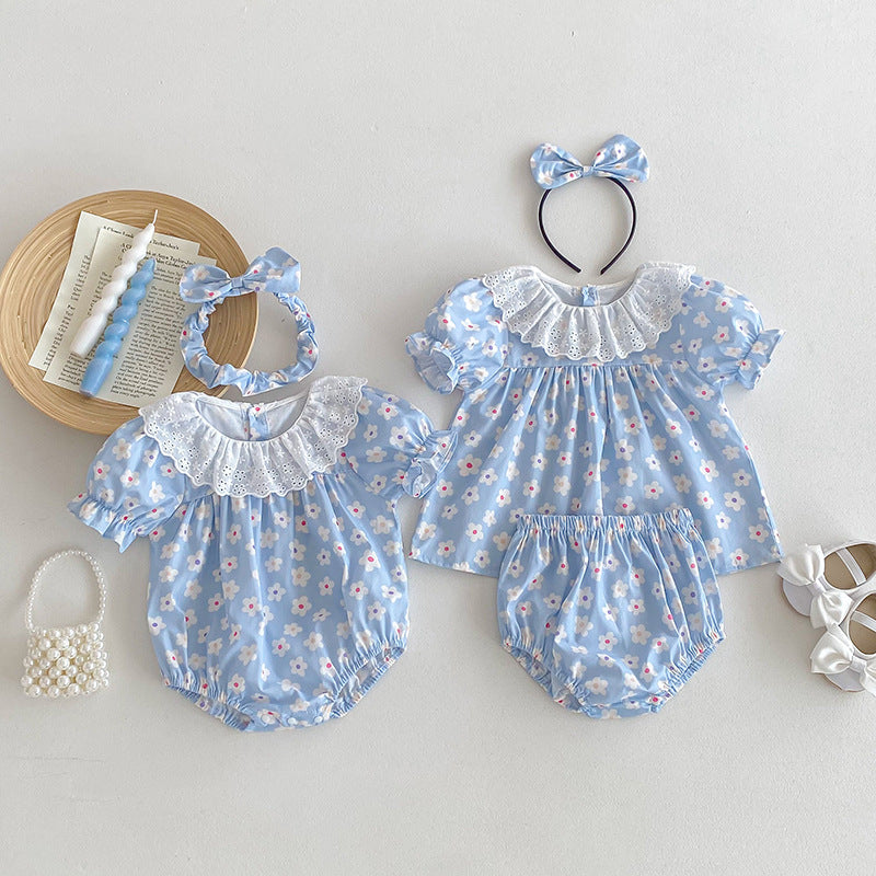 A cute summer dress for girls featuring a floral pattern, short sleeves, and a hollow out collar in blue and light blue colors.