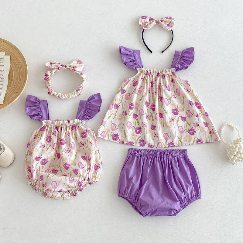 A vibrant summer onesie for girls featuring a floral pattern in purple and apricot colors, designed for comfort and style.