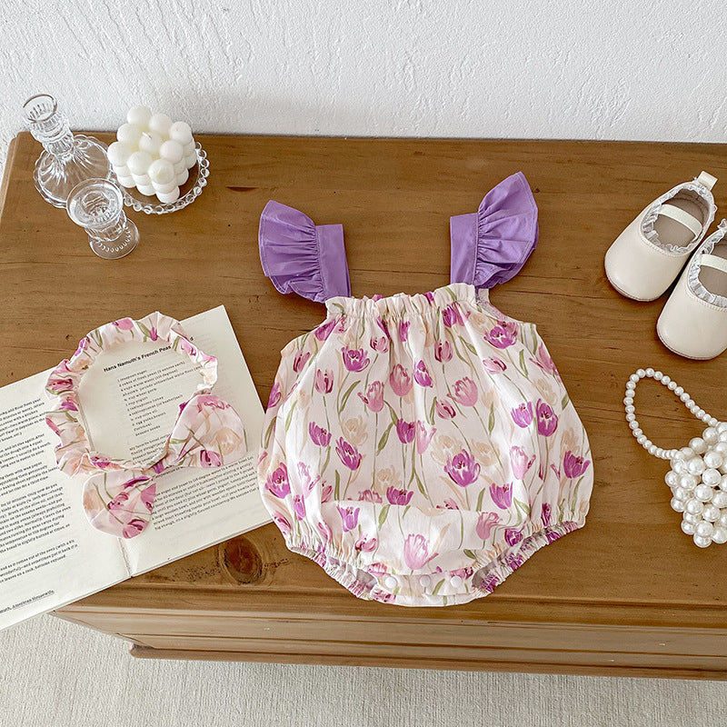 A vibrant summer onesie for girls featuring a floral pattern in purple and apricot colors, designed for comfort and style.