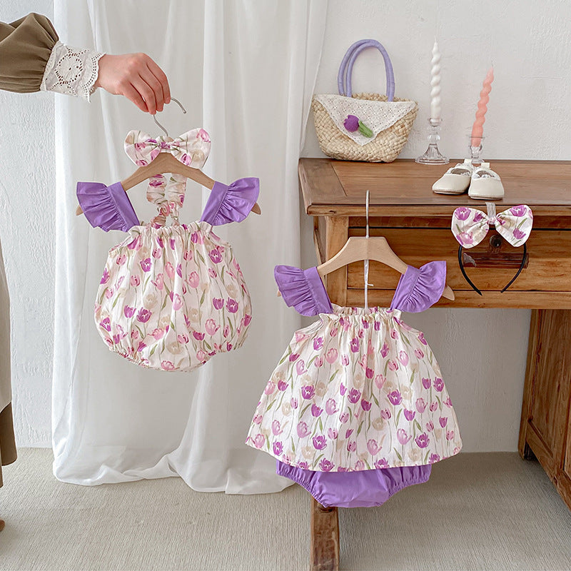 A vibrant summer onesie for girls featuring a floral pattern in purple and apricot colors, designed for comfort and style.