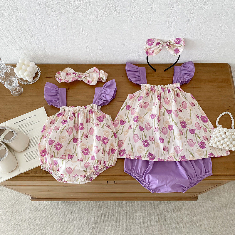 A vibrant summer onesie for girls featuring a floral pattern in purple and apricot colors, designed for comfort and style.