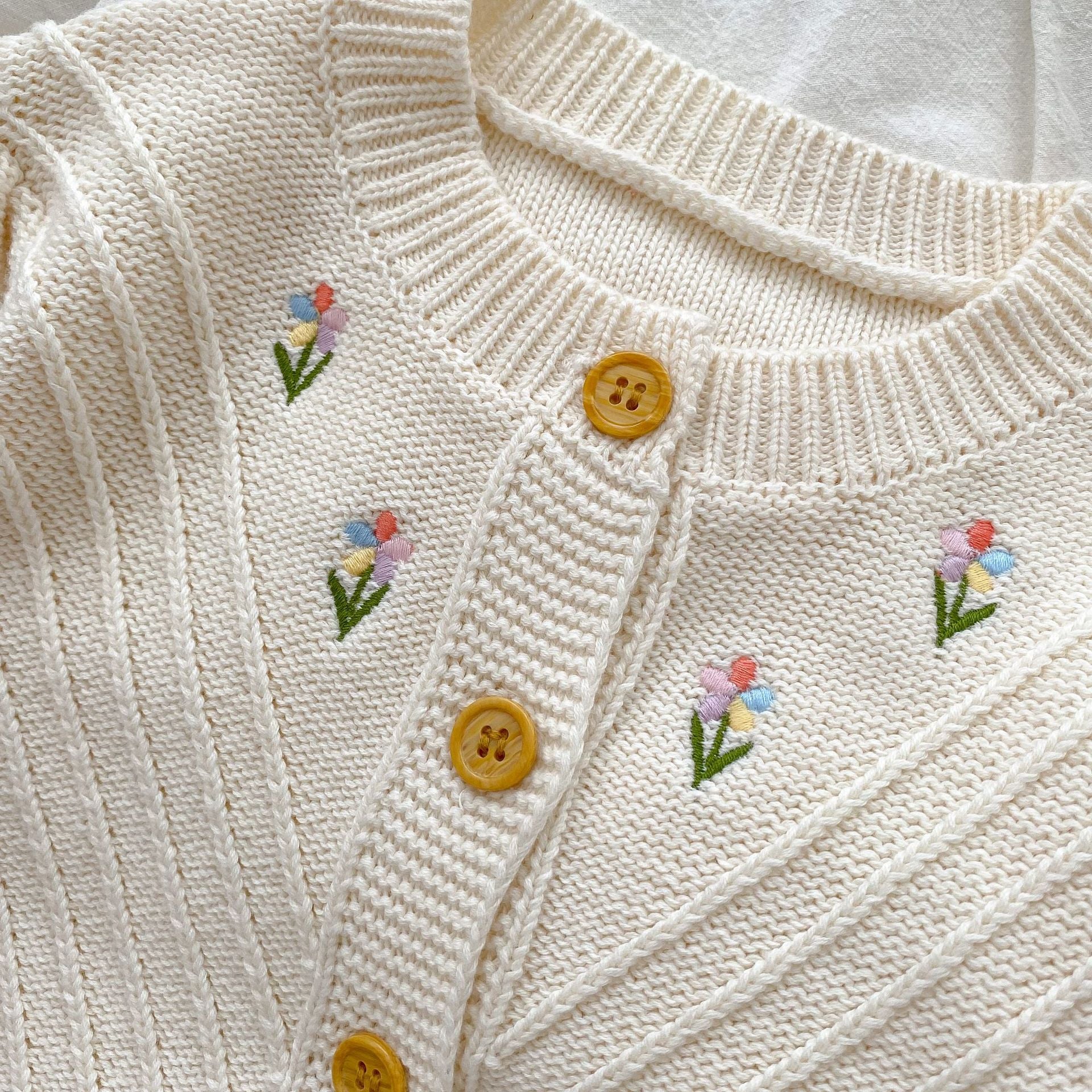 Embroidered Design High Quality Knit Cardigan in beige for baby girls, featuring floral embroidery and soft cotton material.