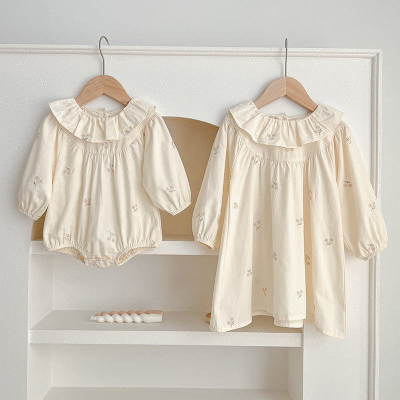 Floral Baby Ruffle Neck Onesies and Girls’ Dress in ivory and beige, featuring a charming floral pattern and ruffle neck design.