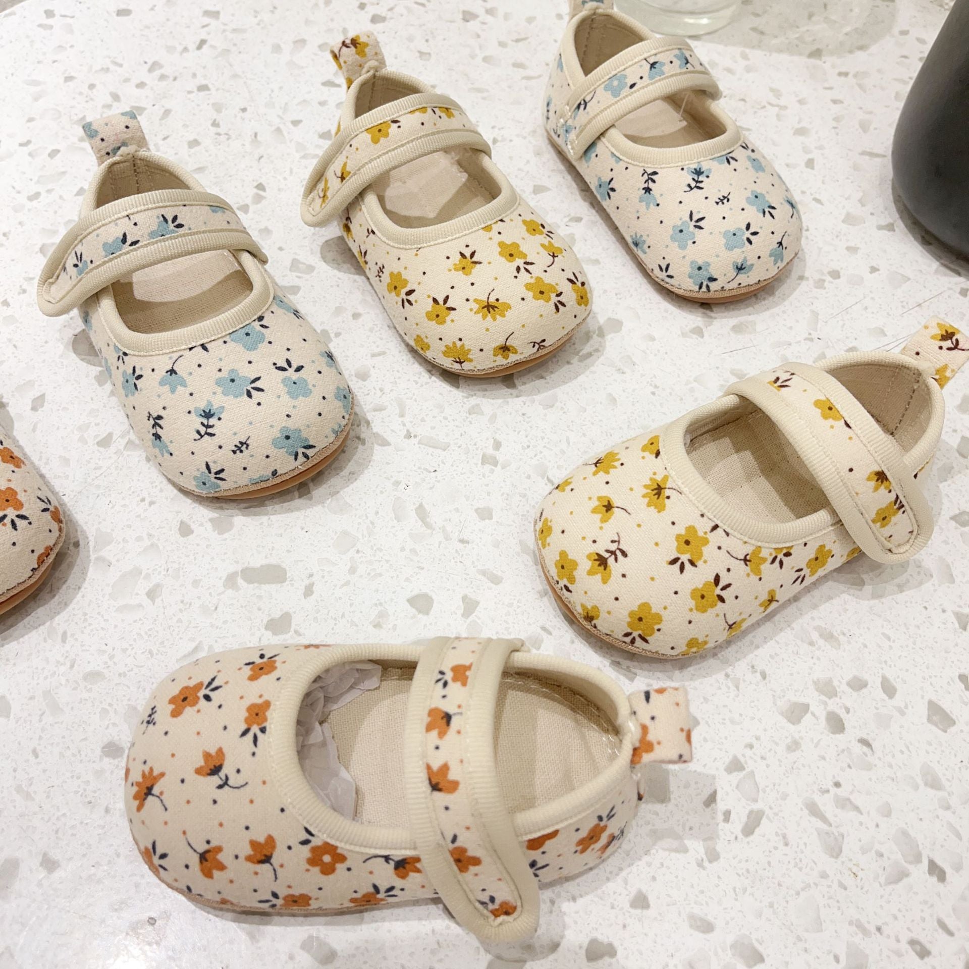 Floral design toddler shoes for baby girls in blue, yellow, and orange colors, made of soft cotton cloth, perfect for autumn wear.
