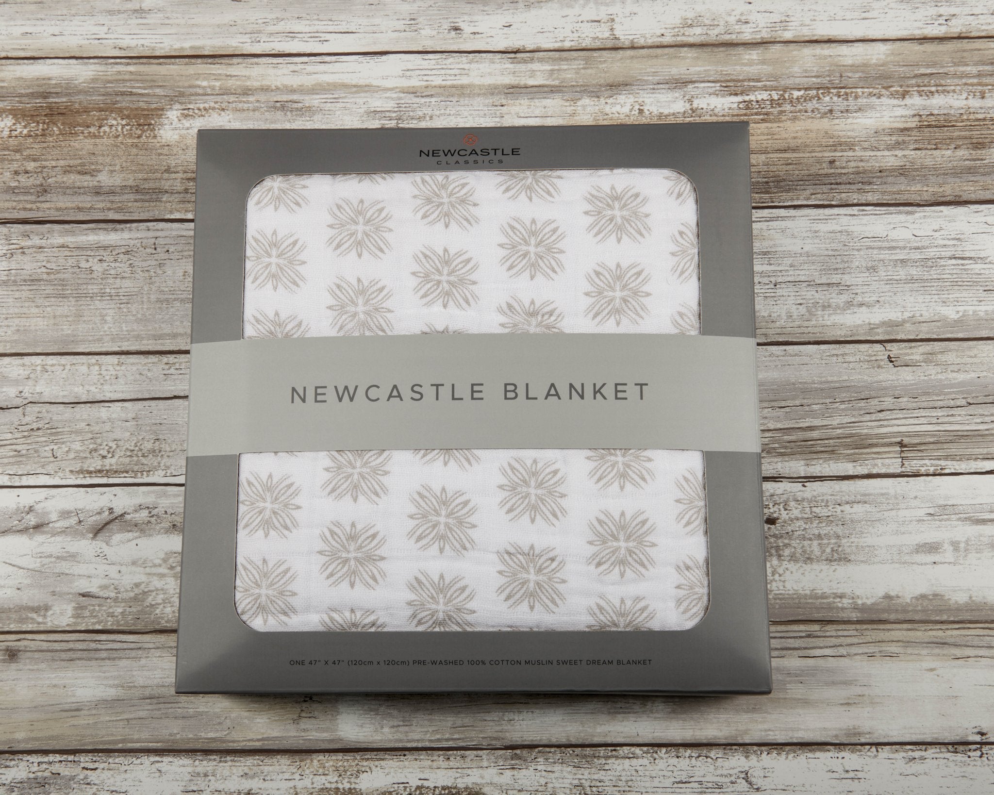Flower Child Cotton Muslin Newcastle Blanket showcasing its soft, breathable, and cozy four-layer design in a vibrant pattern.