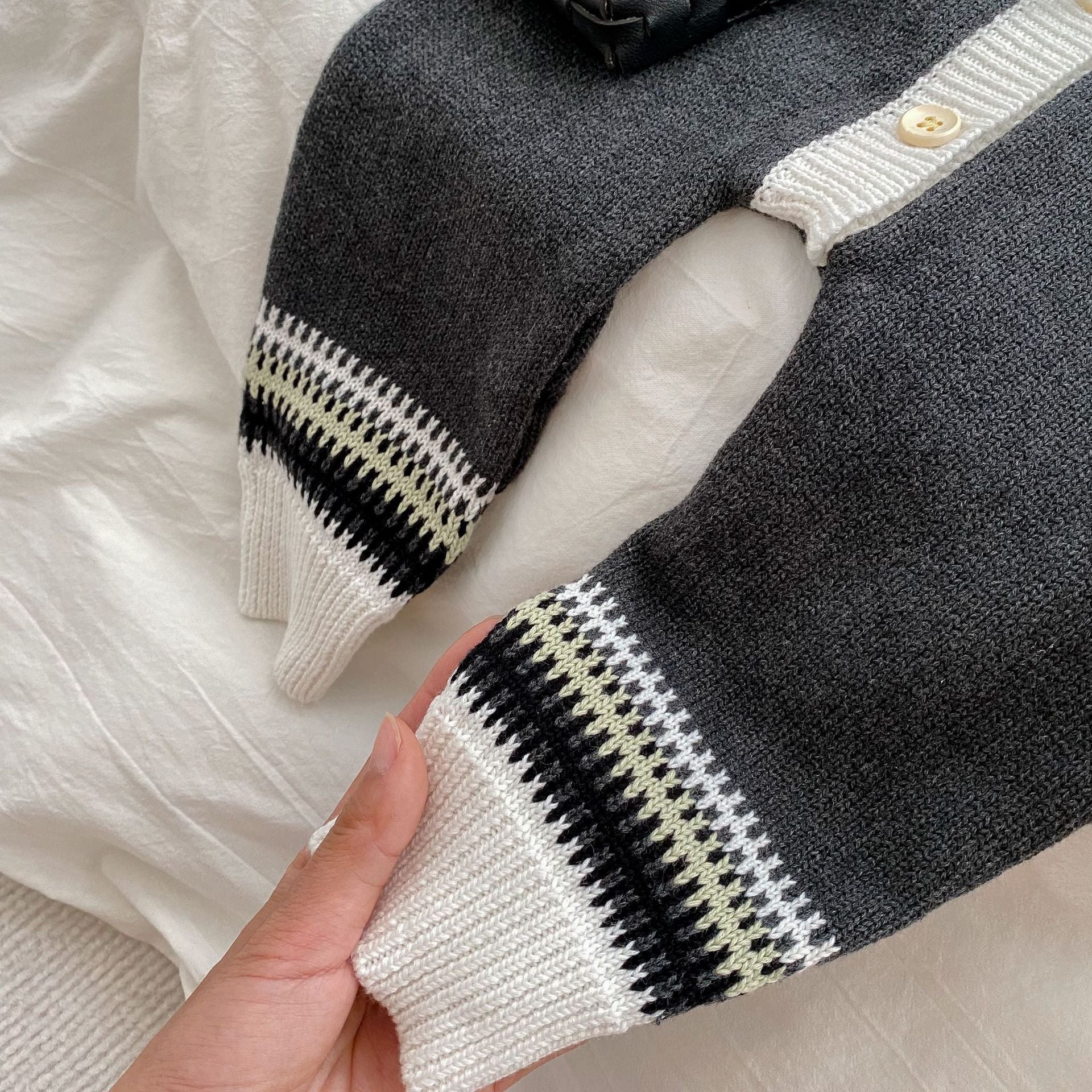 Grey unisex baby knitted romper featuring a geometric pattern, suitable for both baby girls and boys.